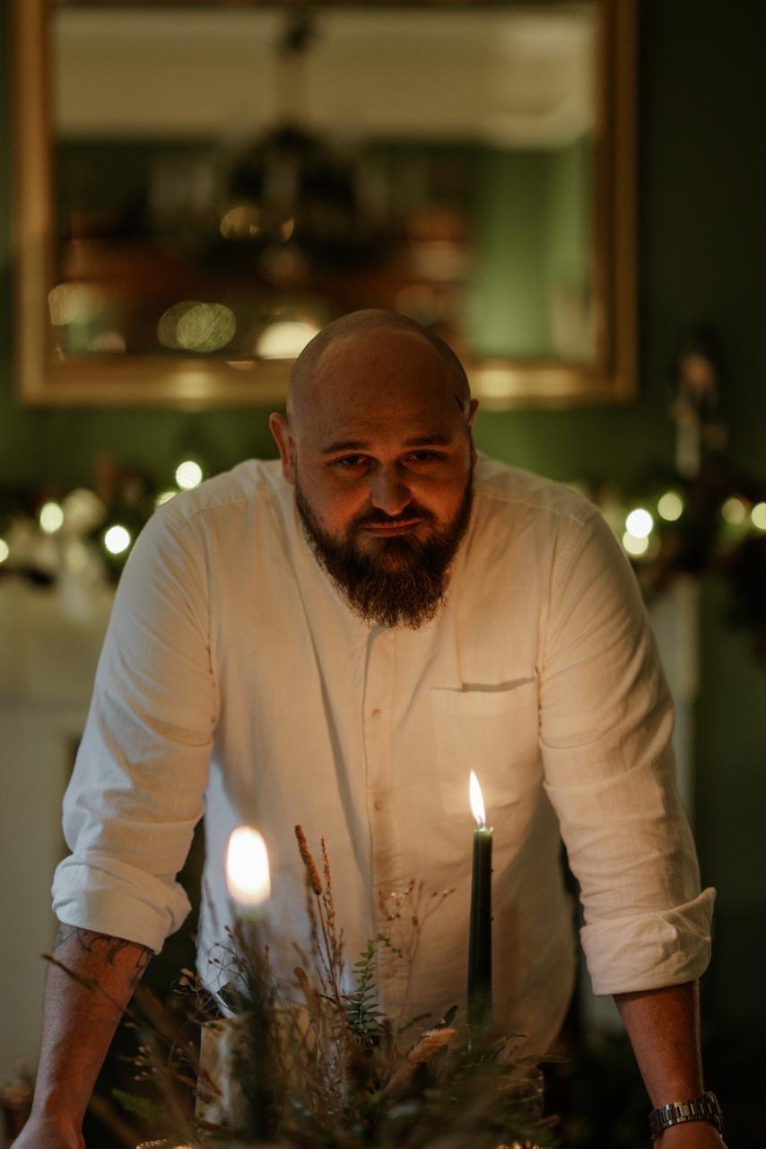 Sam Owen, founder of Animo Hospitality, in a candlelit dining room